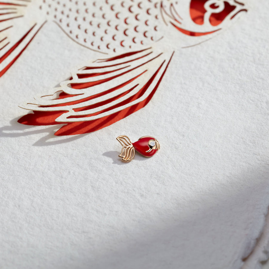 Loquet Abundance Goldfish Charm, on textured fish background